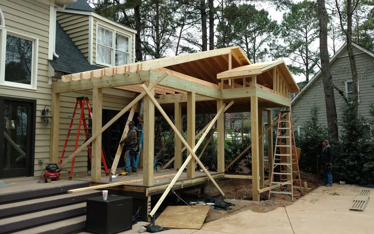Process of building the outdoor kitchen. Outdoor kitchen under construction, features a gable roof.