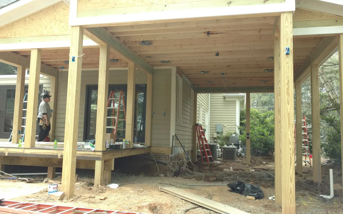 Process of building the outdoor kitchen. Outdoor kitchen under construction, features a gable roof.