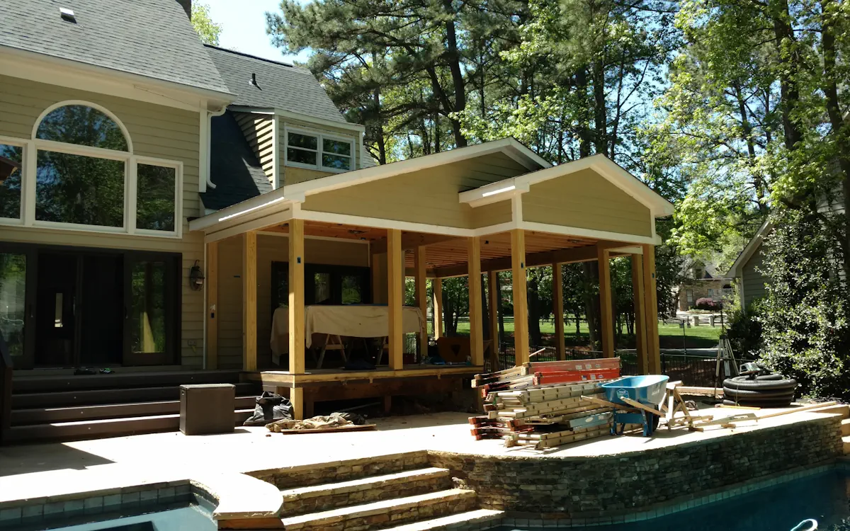 Outdoor kitchen under construction, features a gable roof.