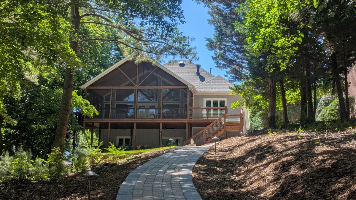 Completed Lake House Revival screened porch, deck, stairs, and landscaped path.