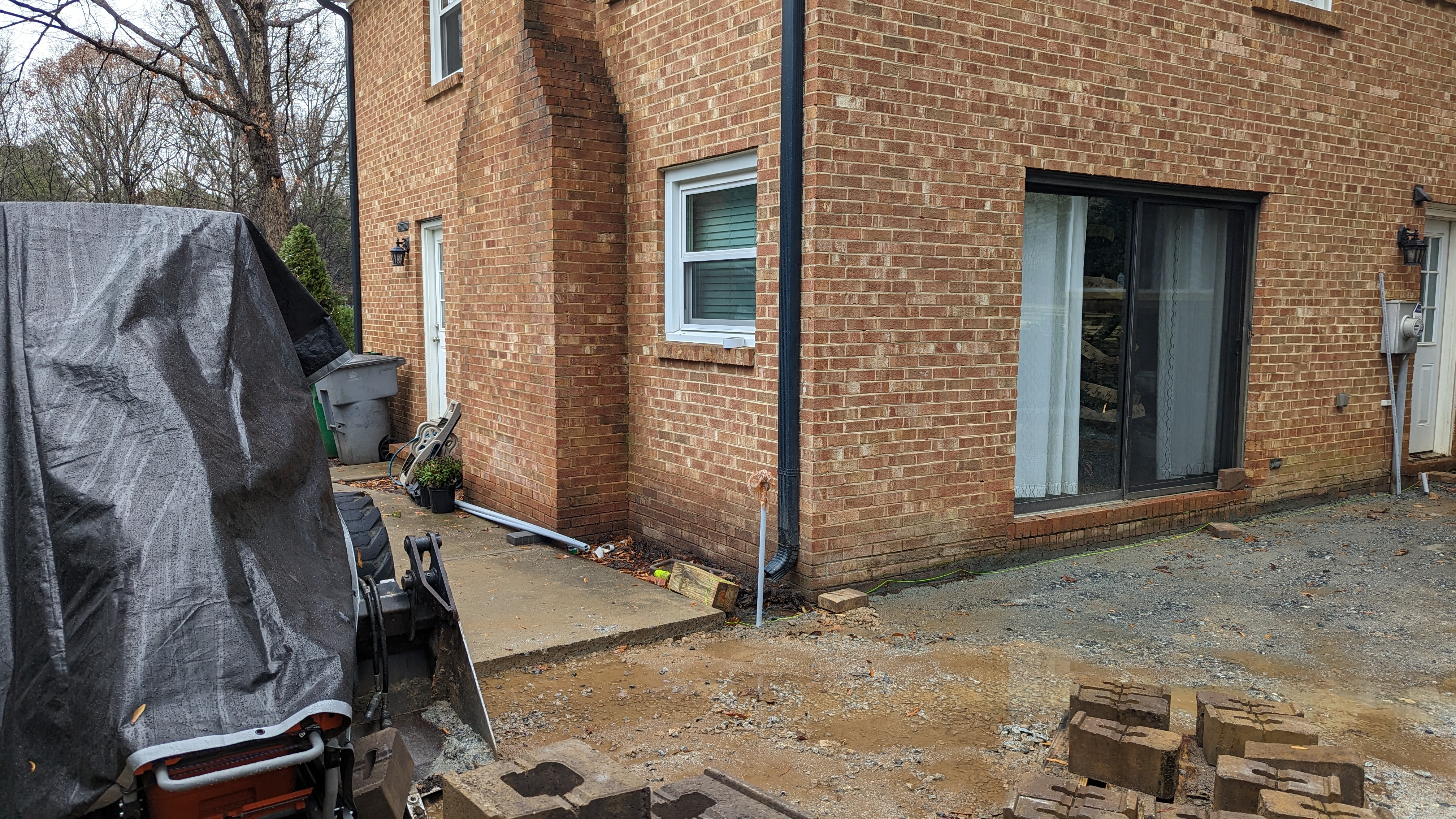 The new sliding patio door is in place before the patio stonework begins.