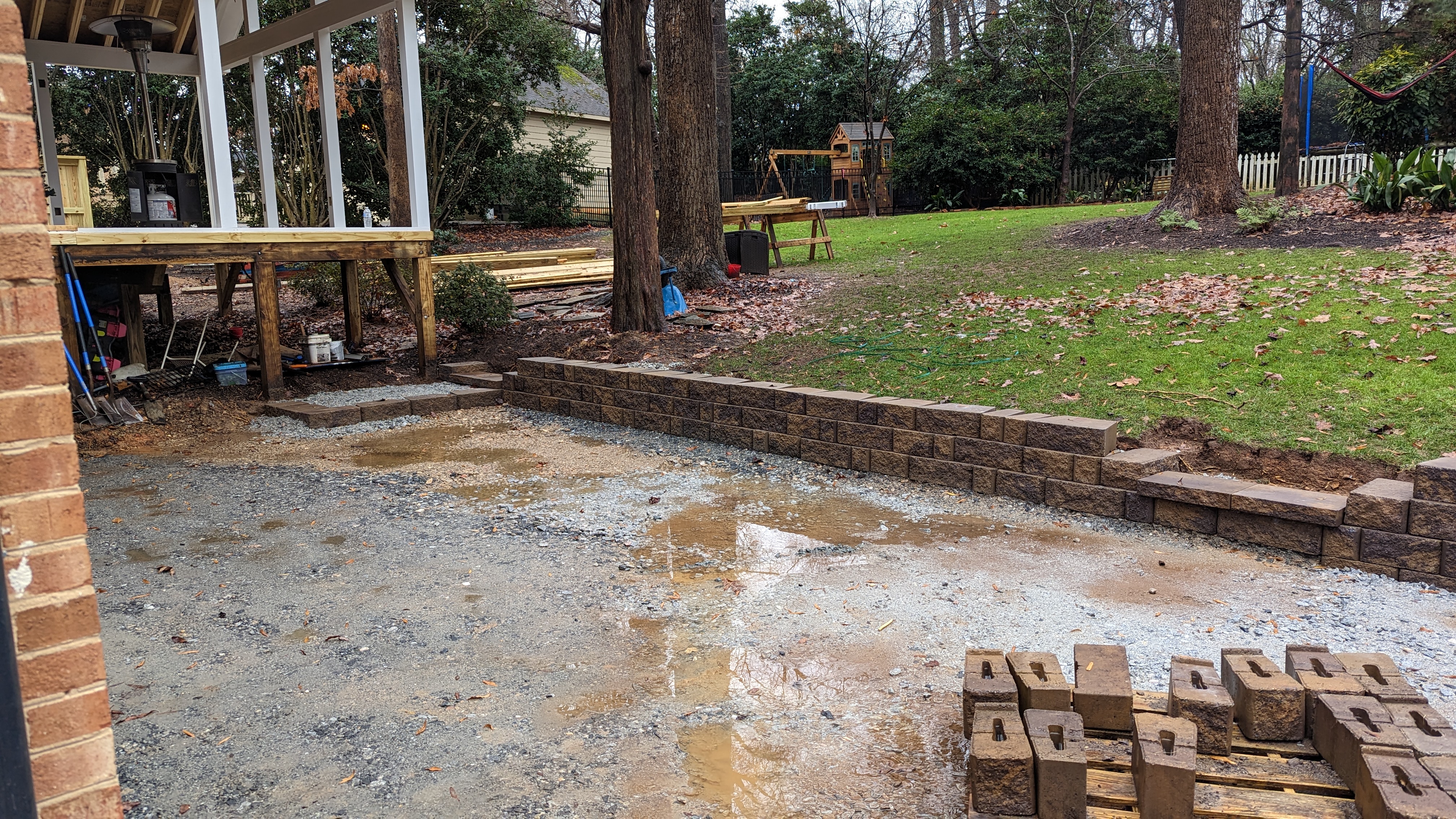 Block courses form the curved retaining wall along the future patio.
