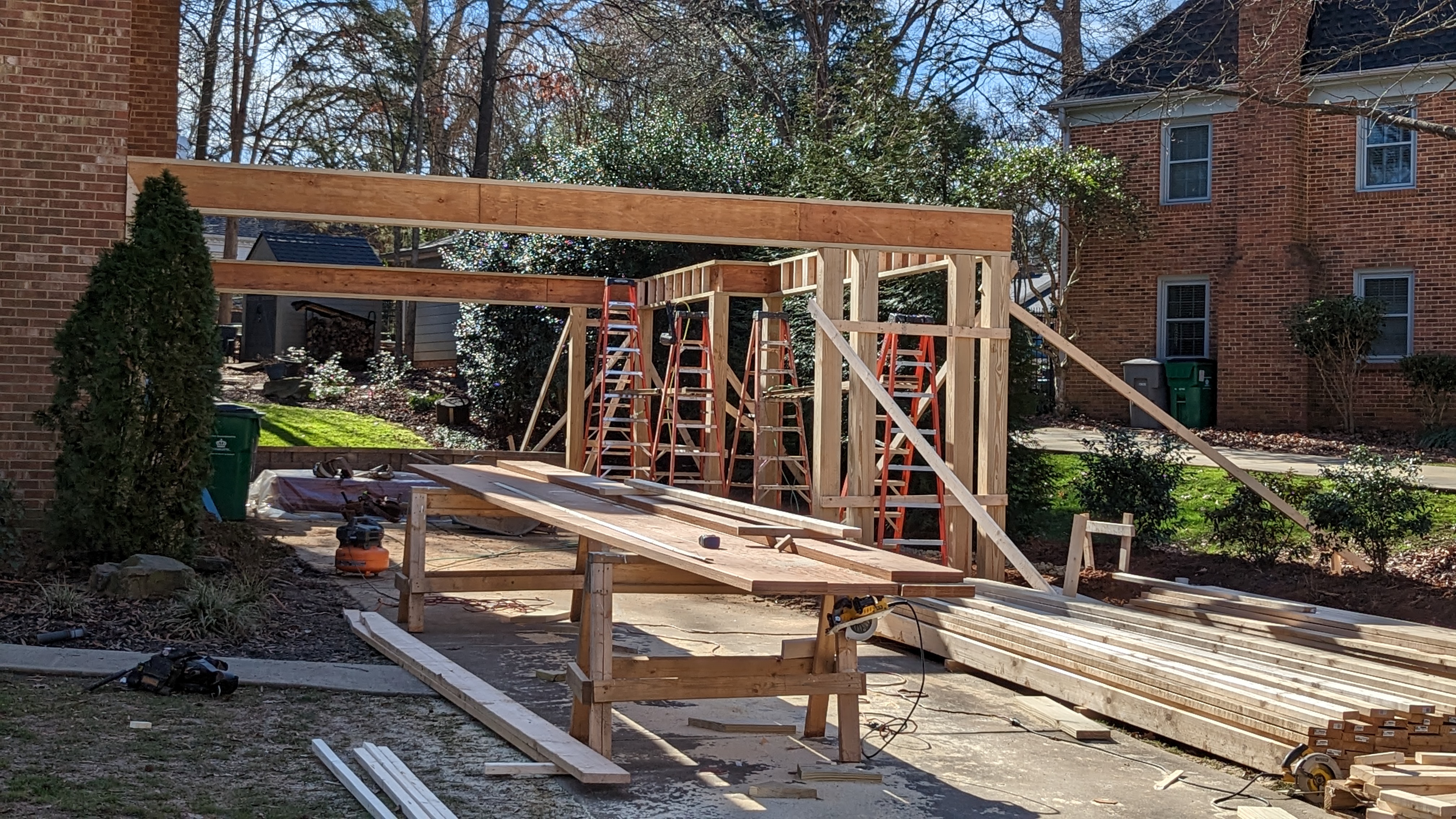Carport posts and beams establish the new covered parking area.