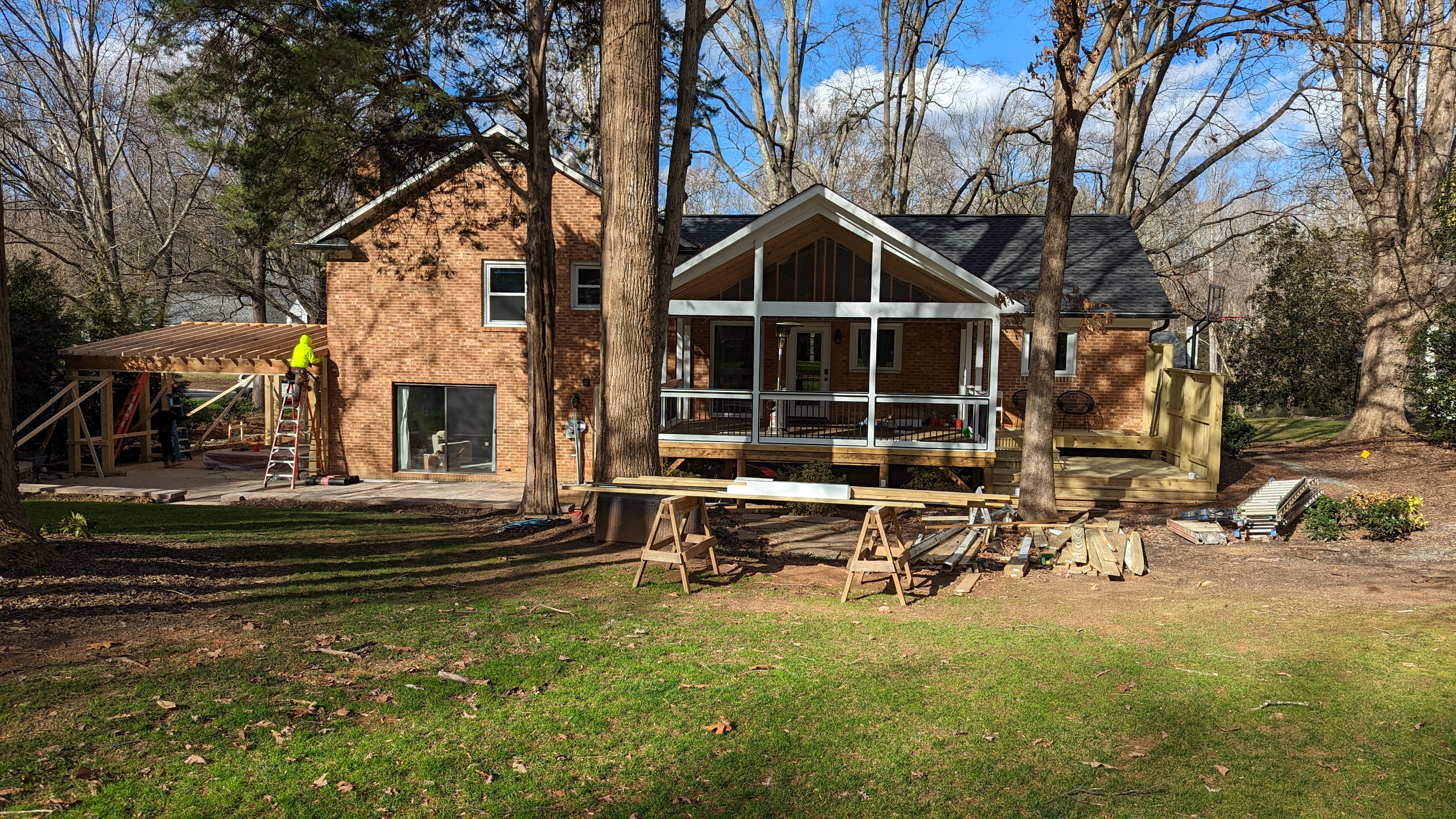 Porch roof framing remains visible before the finished ceiling is installed.