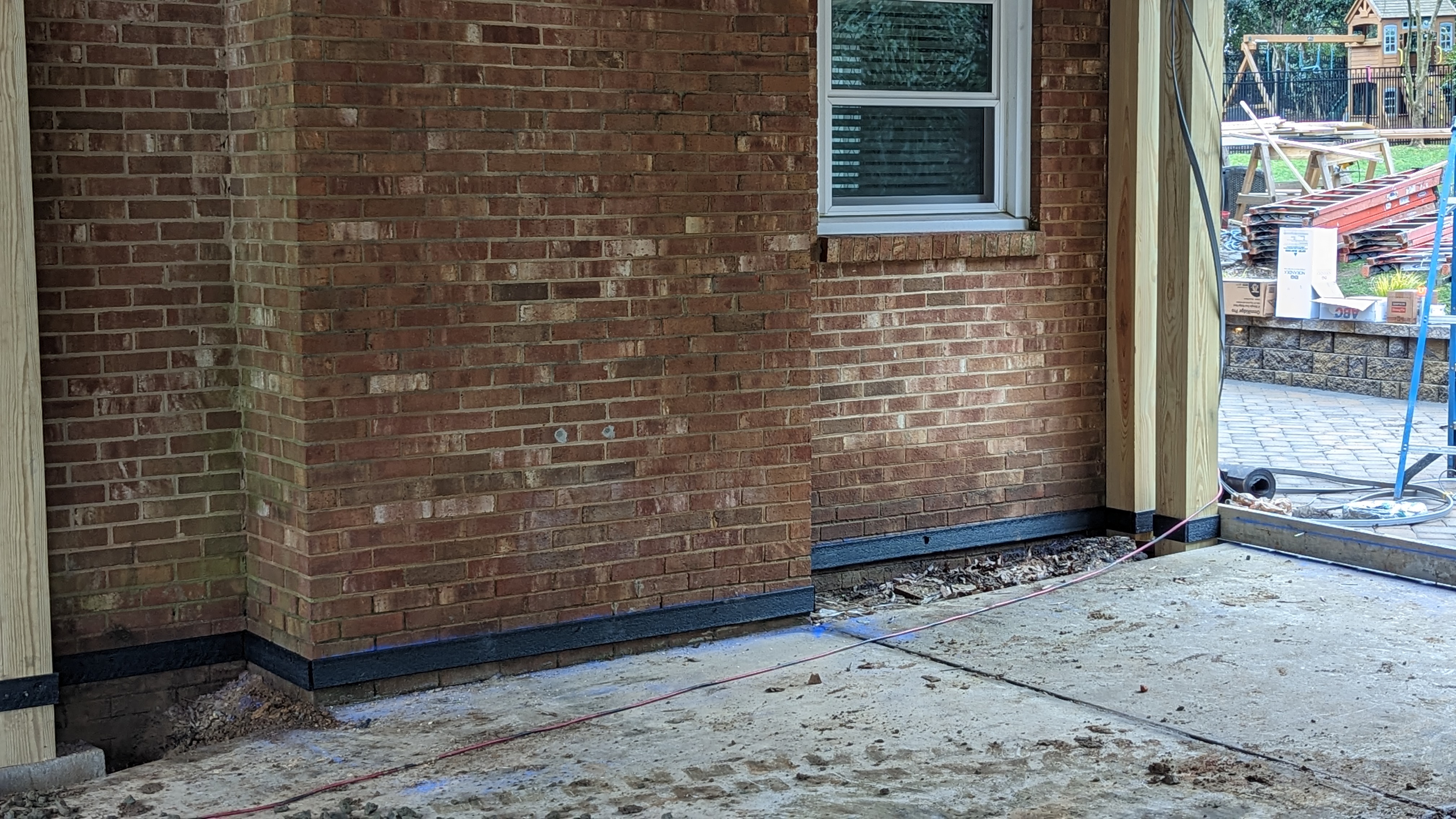 Forms and ground preparation continue around the carport posts.