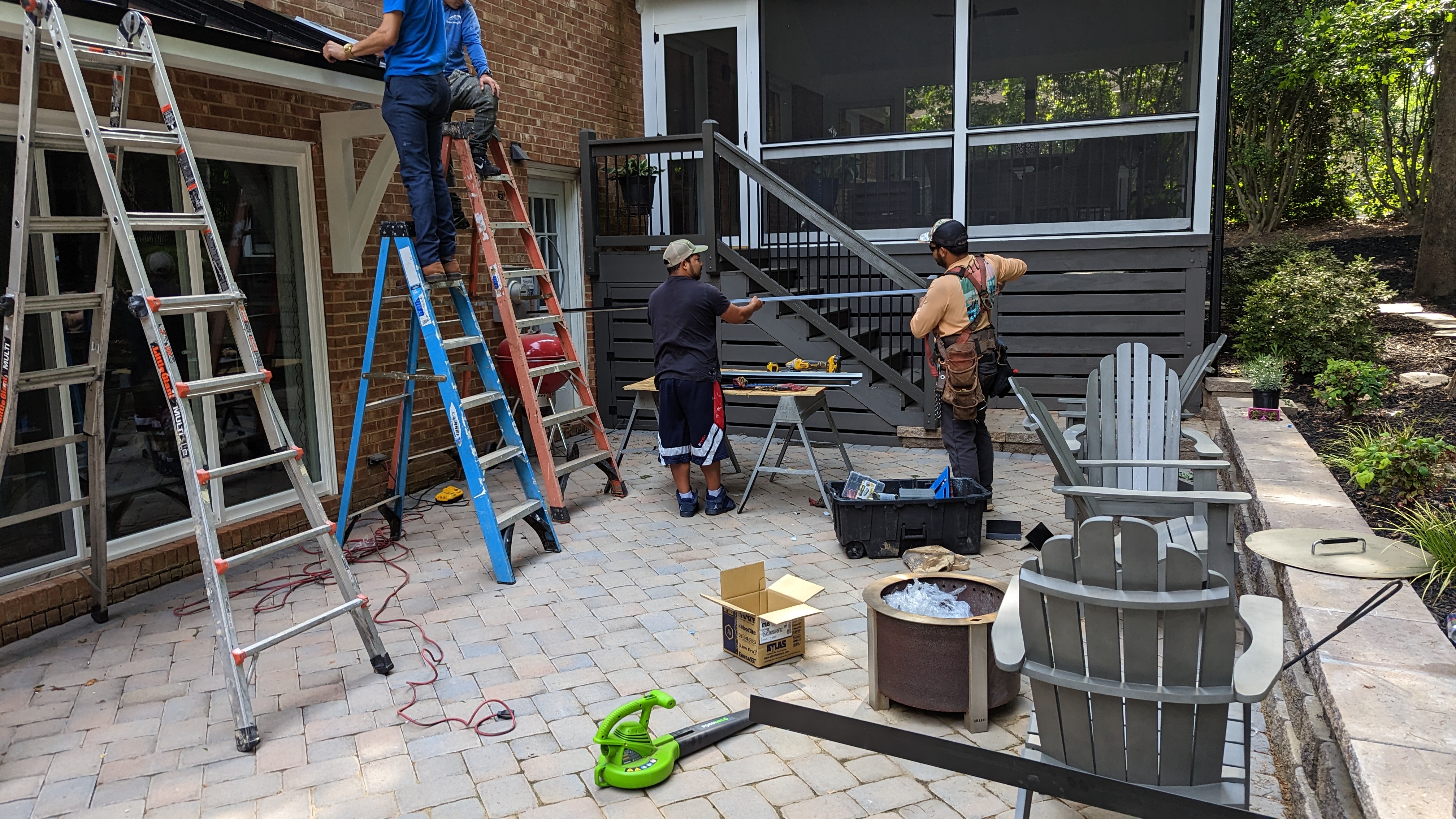The standing-seam metal overhang is installed above the sliding patio door.